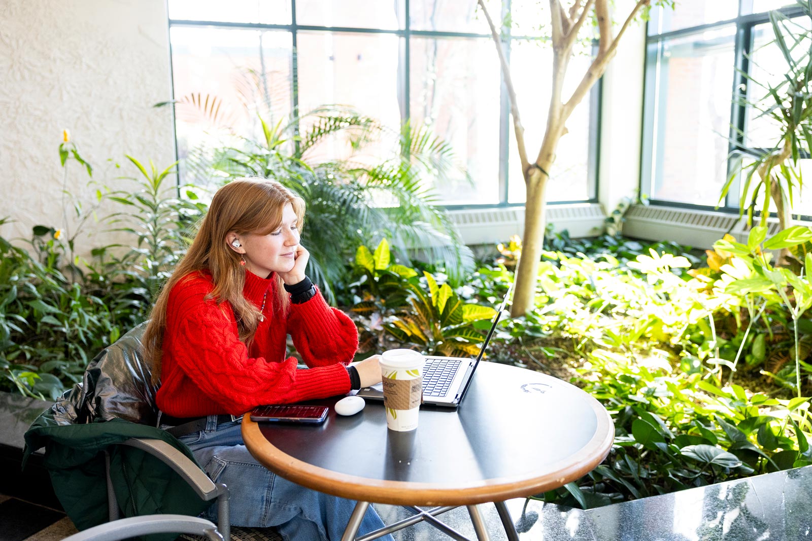 Student with laptop in solarium