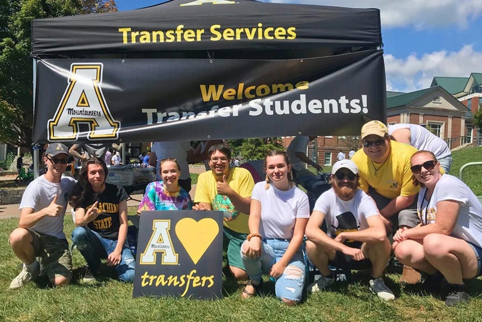 Transfer students with welcome banner
