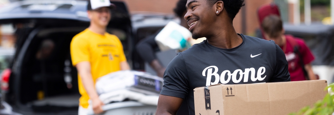 student moving into a residence hall